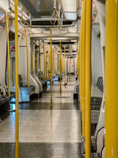 Interior view of Saint-Germain-en-Laye metro station in the UK, featuring a tiled wall with vertical sections in blue, yellow, orange, and pink colors. The station has a modern ceiling with black stru
